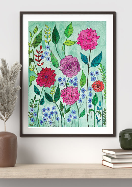 Framed floral art print featuring watercolor-style pink, red, blue, and green flowers on a mint background, displayed on a shelf with decorative vases and books.